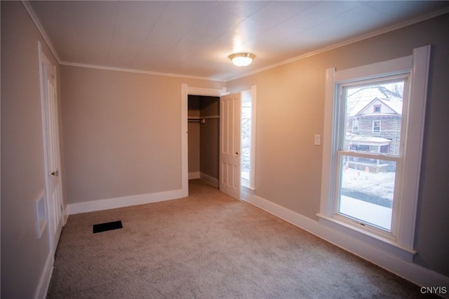 unfurnished bedroom with a closet, light colored carpet, and ornamental molding