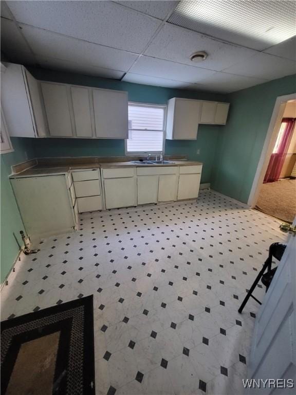 kitchen featuring a paneled ceiling and sink