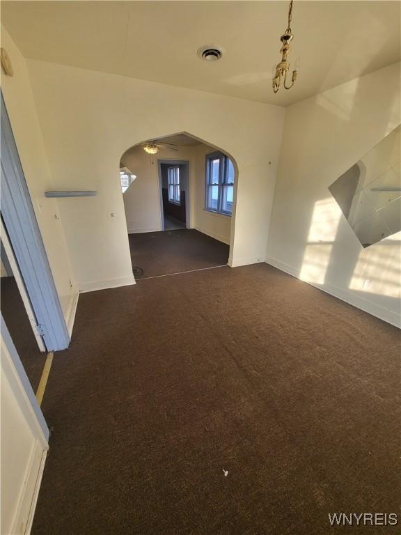 empty room with dark colored carpet