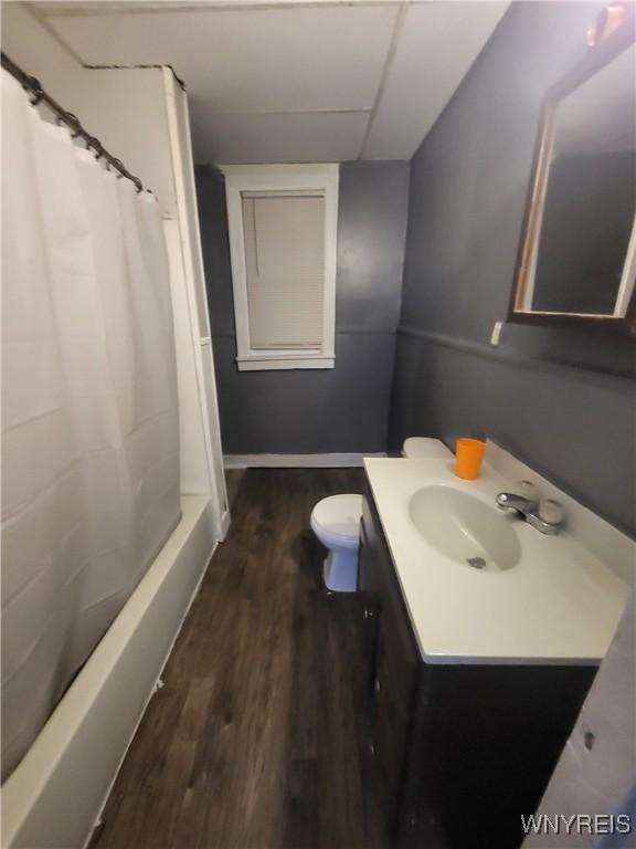 bathroom with a shower with curtain, vanity, toilet, and wood-type flooring