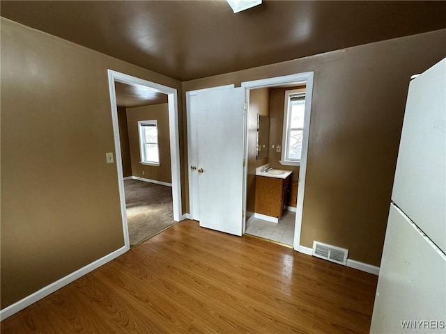 interior space featuring light hardwood / wood-style floors and a healthy amount of sunlight