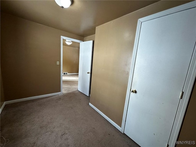 corridor with light colored carpet