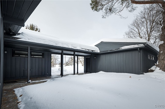 view of snow covered rear of property