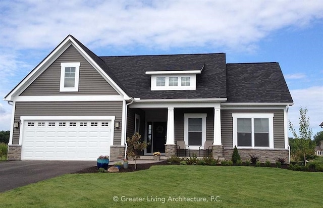 craftsman-style house featuring a porch, a garage, and a front lawn