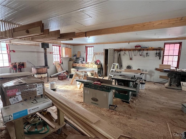 misc room featuring concrete flooring, a workshop area, and a healthy amount of sunlight