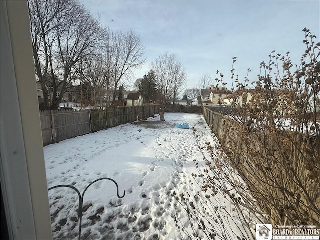 view of yard layered in snow