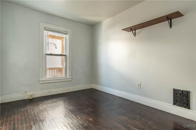 empty room with dark hardwood / wood-style floors