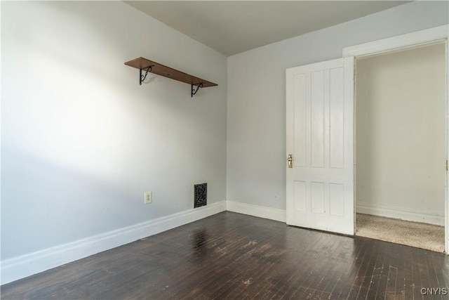 spare room with dark wood-type flooring