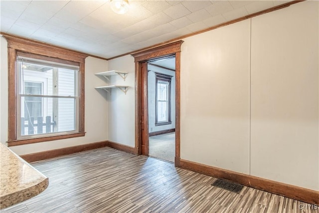 interior space featuring hardwood / wood-style flooring and ornamental molding