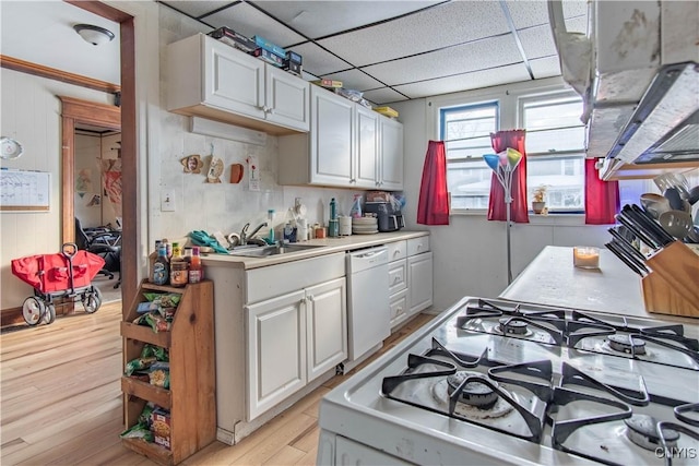 kitchen featuring stove, white cabinets, white dishwasher, and light hardwood / wood-style flooring