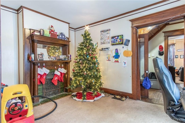 playroom with carpet flooring, a fireplace, and ornamental molding