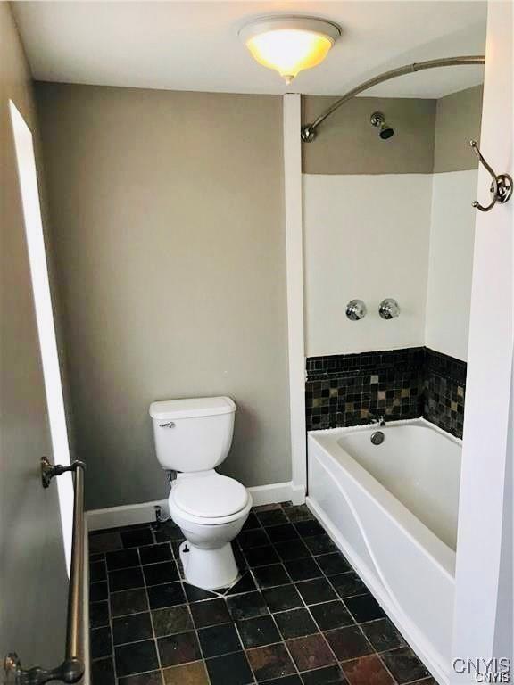 bathroom featuring tile patterned flooring and toilet