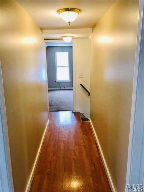 hallway with dark hardwood / wood-style floors