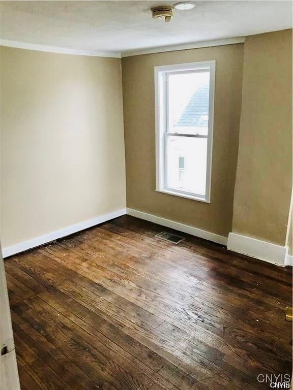 spare room with dark hardwood / wood-style floors