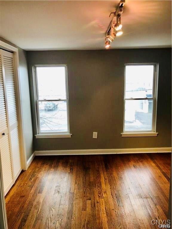 interior space featuring dark hardwood / wood-style flooring and track lighting