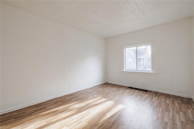 empty room with light hardwood / wood-style floors