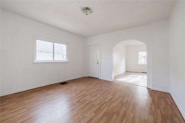 unfurnished room with plenty of natural light and light hardwood / wood-style floors