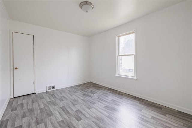 empty room with light hardwood / wood-style flooring