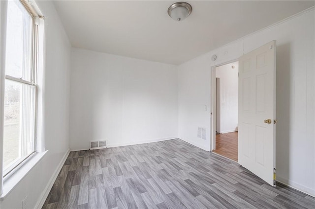 empty room with light hardwood / wood-style flooring