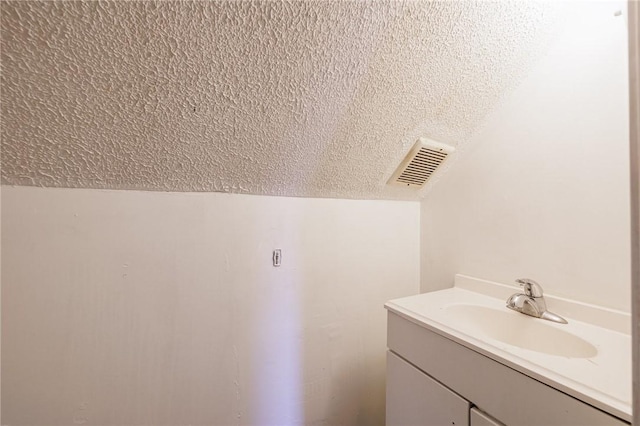 bathroom featuring vanity and a textured ceiling