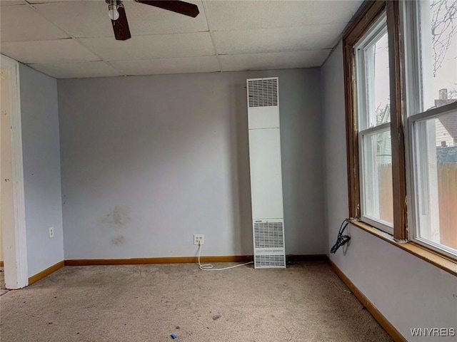 unfurnished room with light carpet, a drop ceiling, and ceiling fan