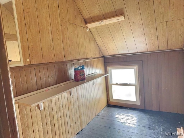 interior space with hardwood / wood-style floors, wooden walls, wooden ceiling, and lofted ceiling