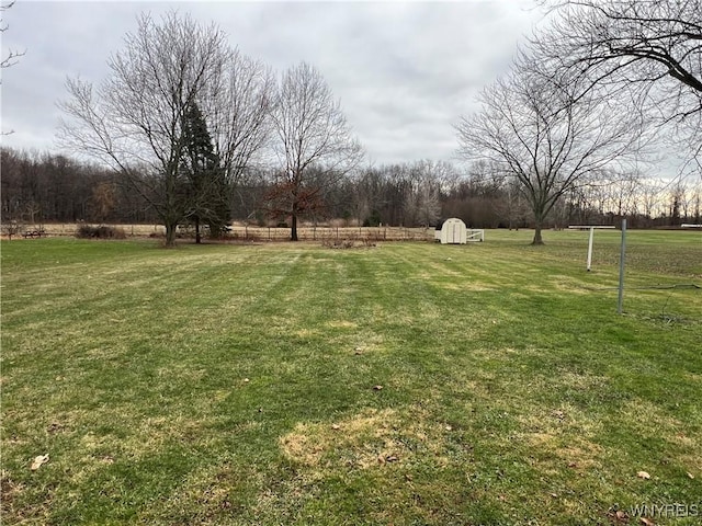 view of yard with a storage unit and a rural view