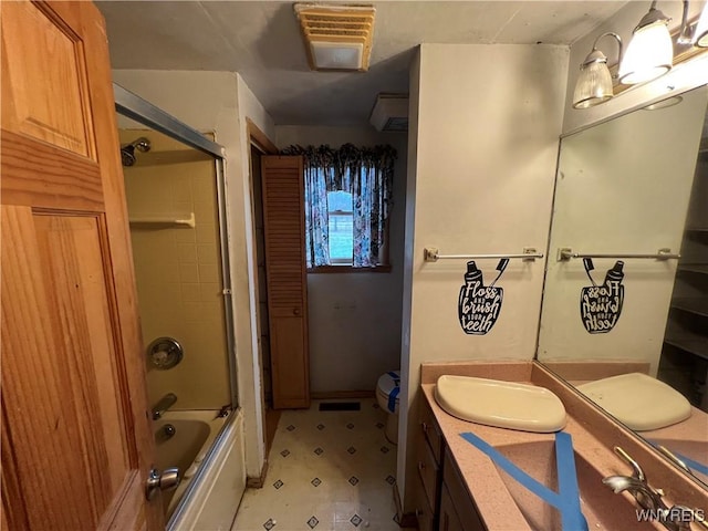 bathroom with vanity and combined bath / shower with glass door