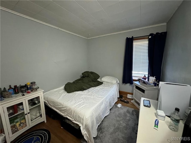 bedroom with dark wood-type flooring and ornamental molding