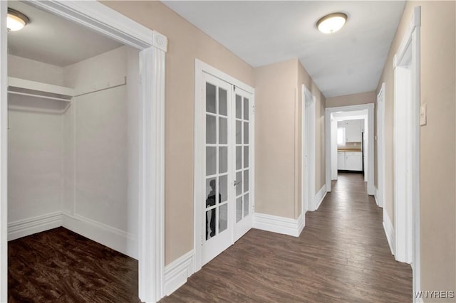 corridor featuring dark wood-type flooring and french doors