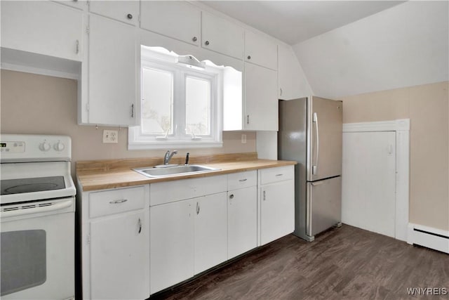 kitchen with electric stove, stainless steel fridge, sink, and white cabinets