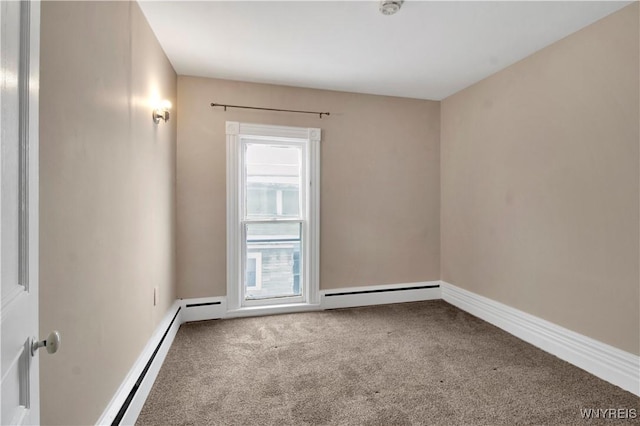 spare room featuring carpet flooring and a baseboard radiator