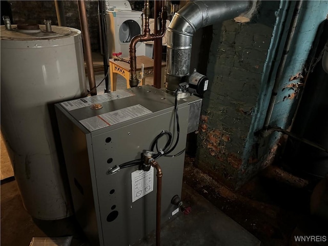 utility room featuring gas water heater and washer / clothes dryer