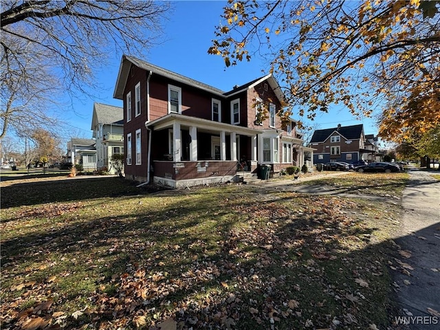 view of property exterior featuring covered porch and a yard