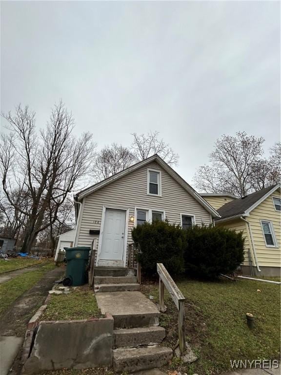 bungalow-style home featuring a front lawn