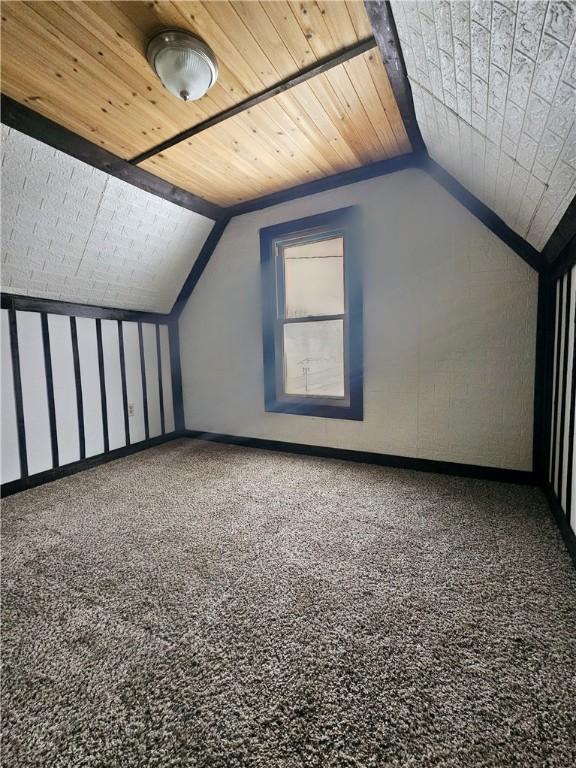 additional living space with carpet floors, lofted ceiling, and wood ceiling