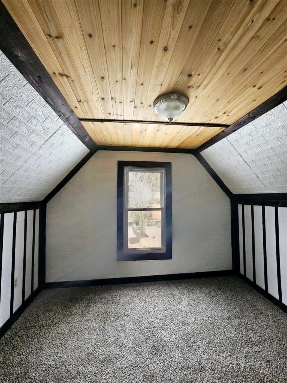 additional living space featuring carpet, wood ceiling, and lofted ceiling