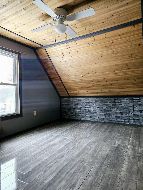 additional living space featuring dark hardwood / wood-style floors, ceiling fan, wood ceiling, and lofted ceiling