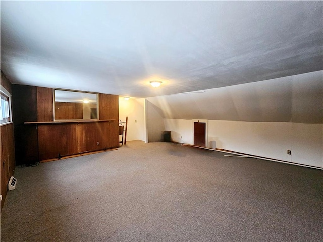 additional living space featuring carpet and lofted ceiling