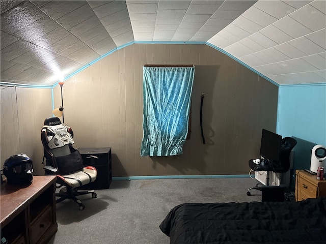 carpeted bedroom with wood walls and lofted ceiling