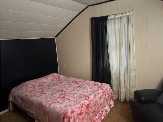 bedroom featuring carpet and vaulted ceiling