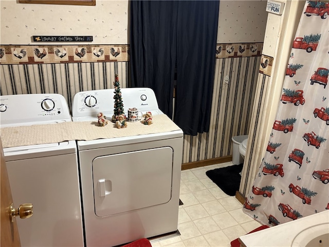 washroom featuring washing machine and dryer and light tile patterned floors