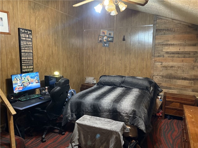 bedroom featuring ceiling fan, wooden walls, and vaulted ceiling