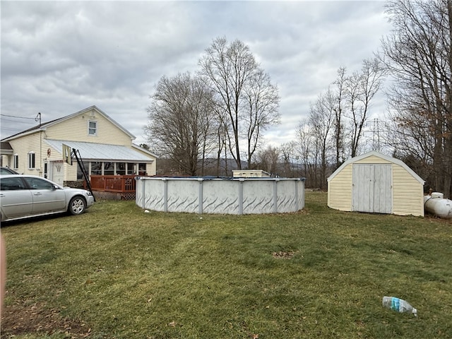 view of yard featuring a pool side deck and a shed