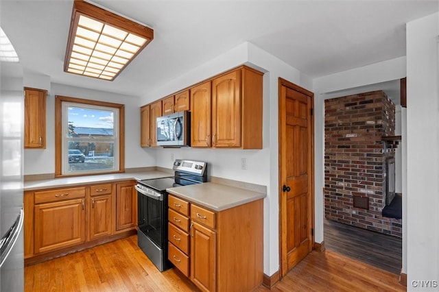 kitchen featuring light wood-type flooring and stainless steel appliances