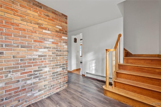 interior space with hardwood / wood-style flooring and a baseboard heating unit