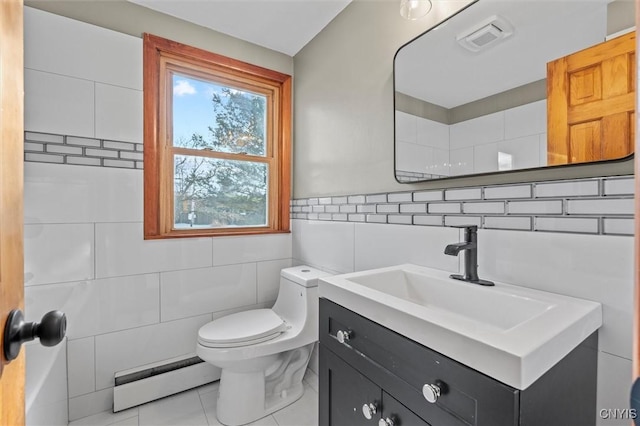 bathroom featuring tile patterned floors, vanity, tile walls, and a baseboard heating unit