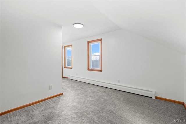 additional living space with carpet, baseboard heating, and vaulted ceiling