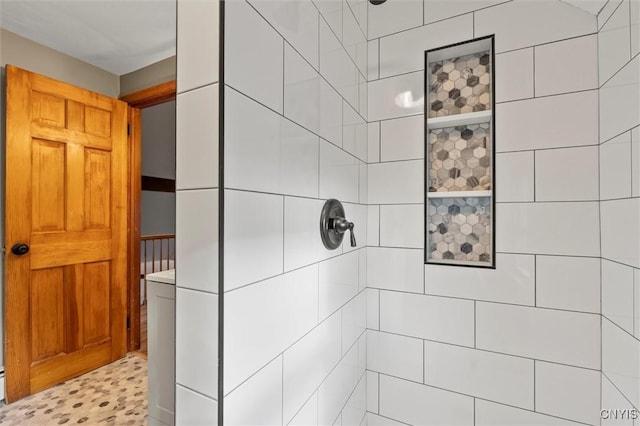 bathroom with a tile shower