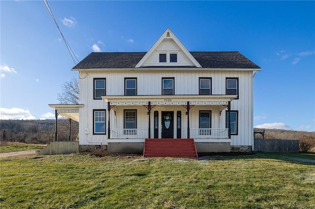 view of front of property featuring covered porch and a front yard